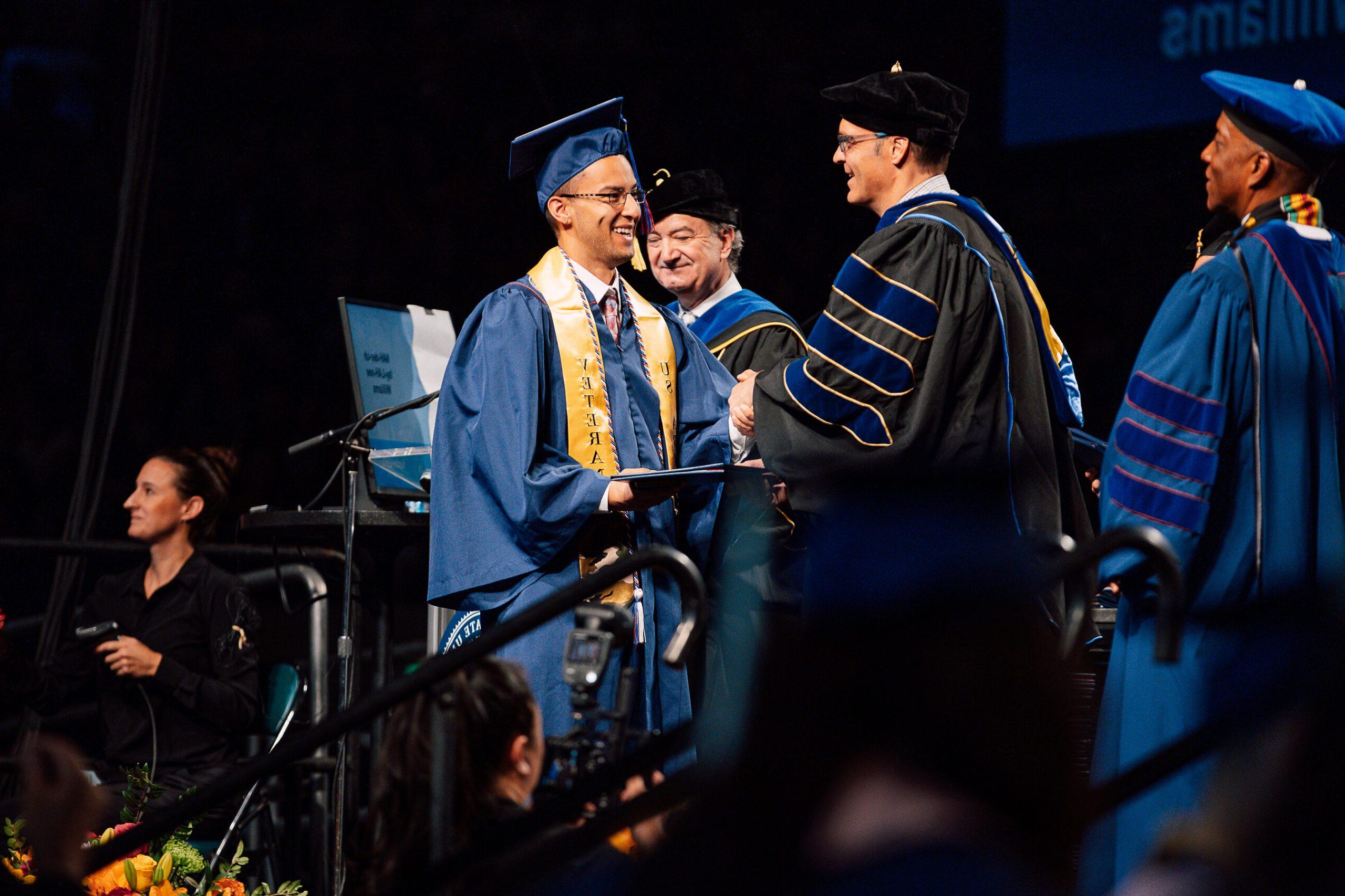 Political Science Student receiving his diploma.